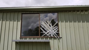 Glass panel on the right has had grey tape stuck to the window as its badly broken